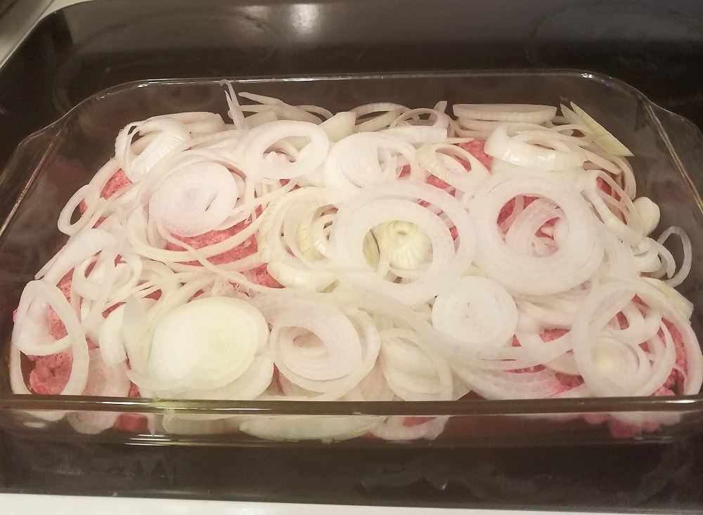 frozen burgers in pan with onions.jpg